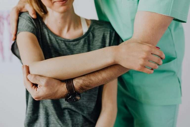 Therapist assisting with arm rehabilitation
