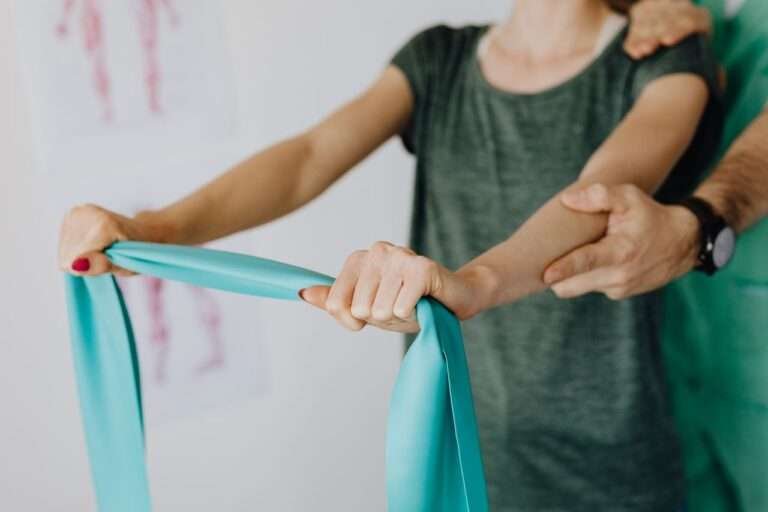 Therapist guiding a resistance band shoulder exercise