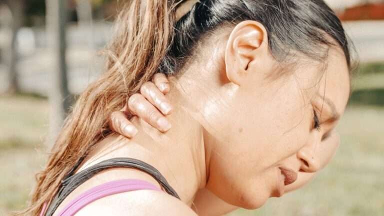 Woman holding her neck in discomfort